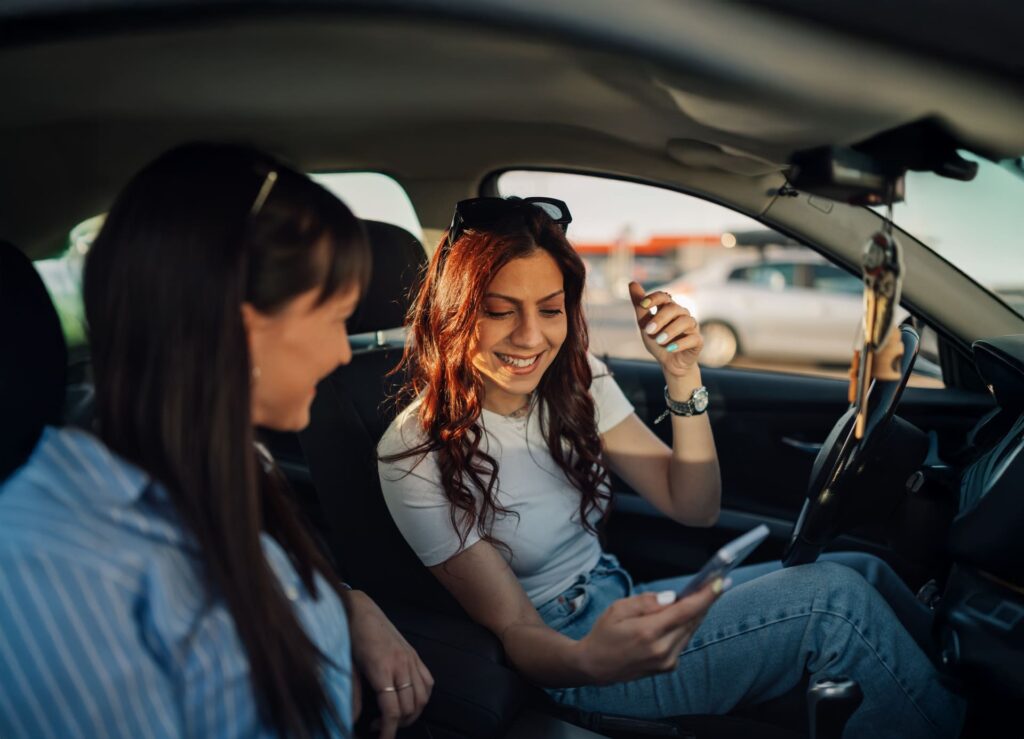 Enjoy Ride Corfu Car Rental happy friends looking at their phone