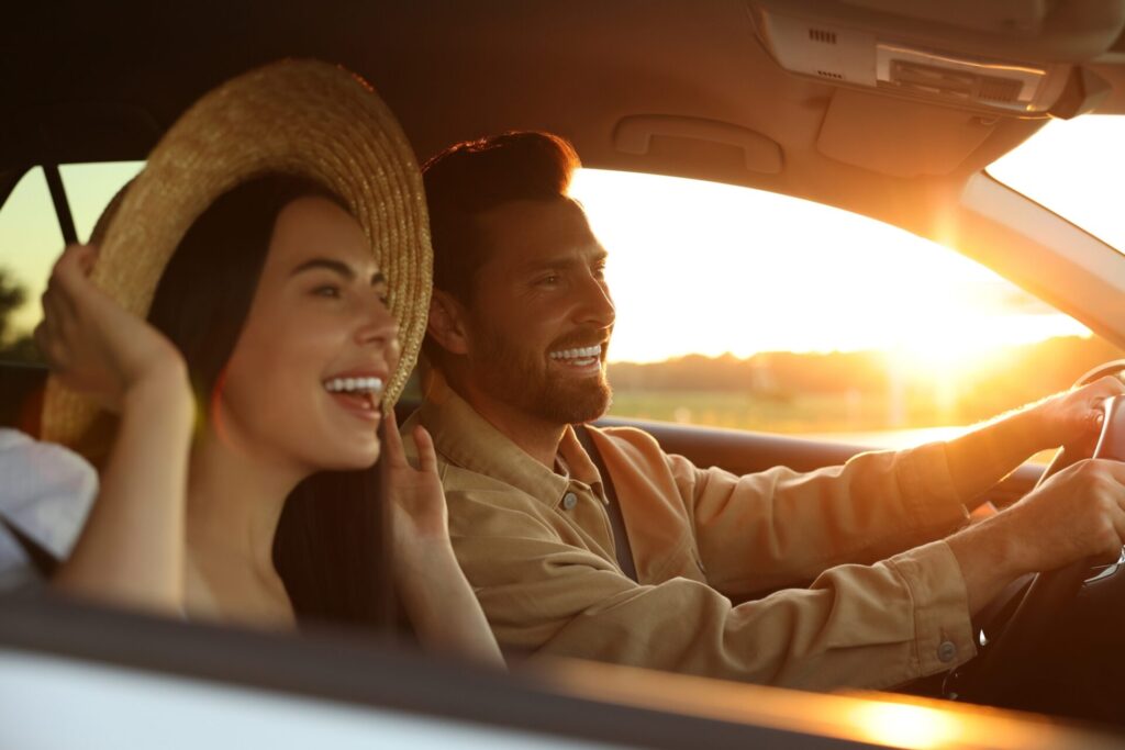Enjoy Ride Corfu Car Rental Happy couple enjoying the sunset driving